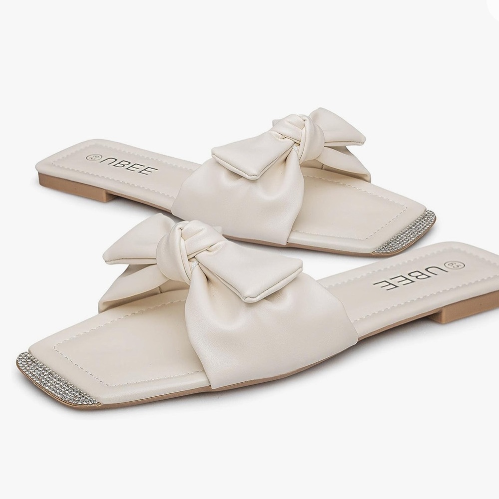 Cream white, bow tie sandals with rhinestones at the top.